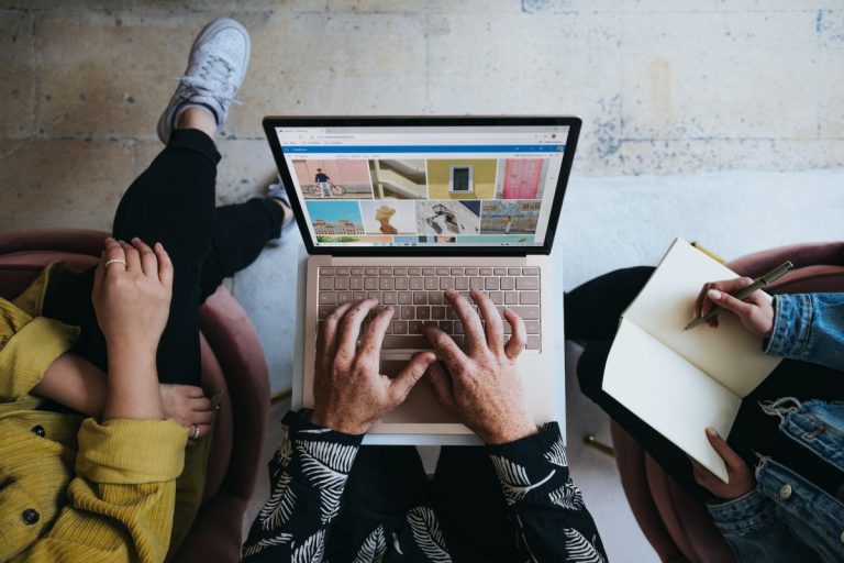 People working on a laptop to create a digital marketing campaign.